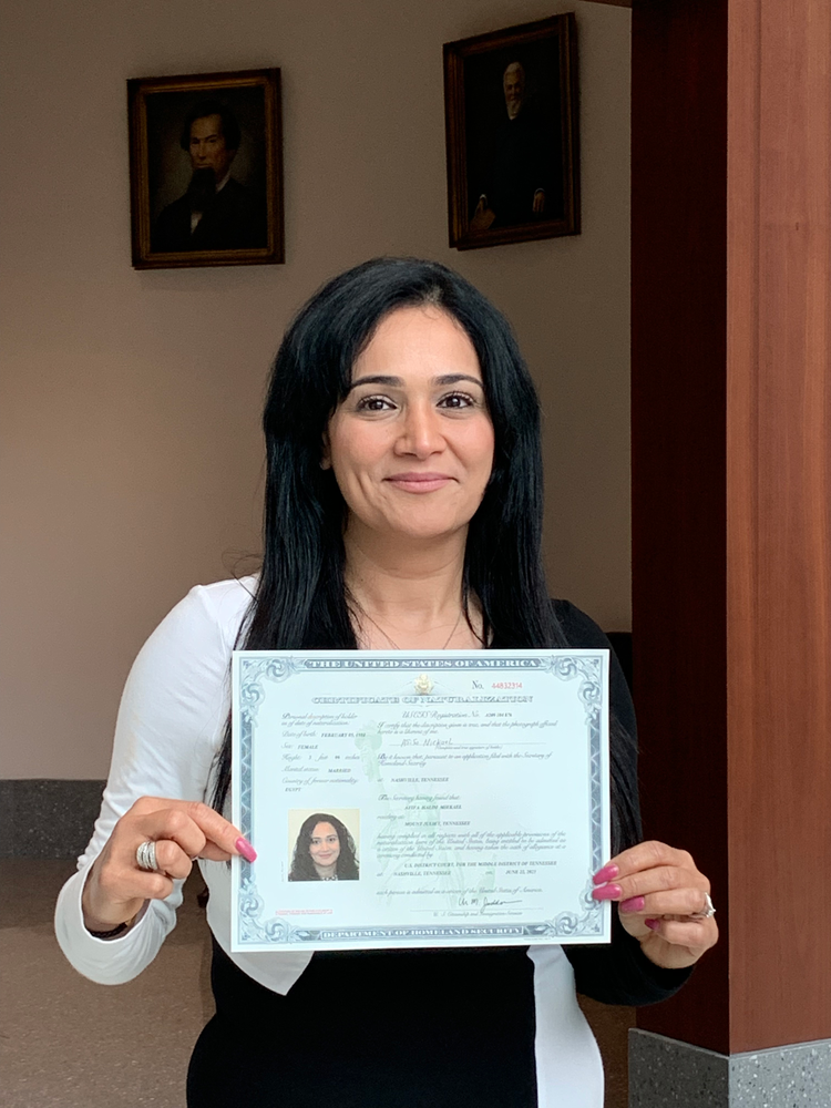 woman with certificate of citizenship